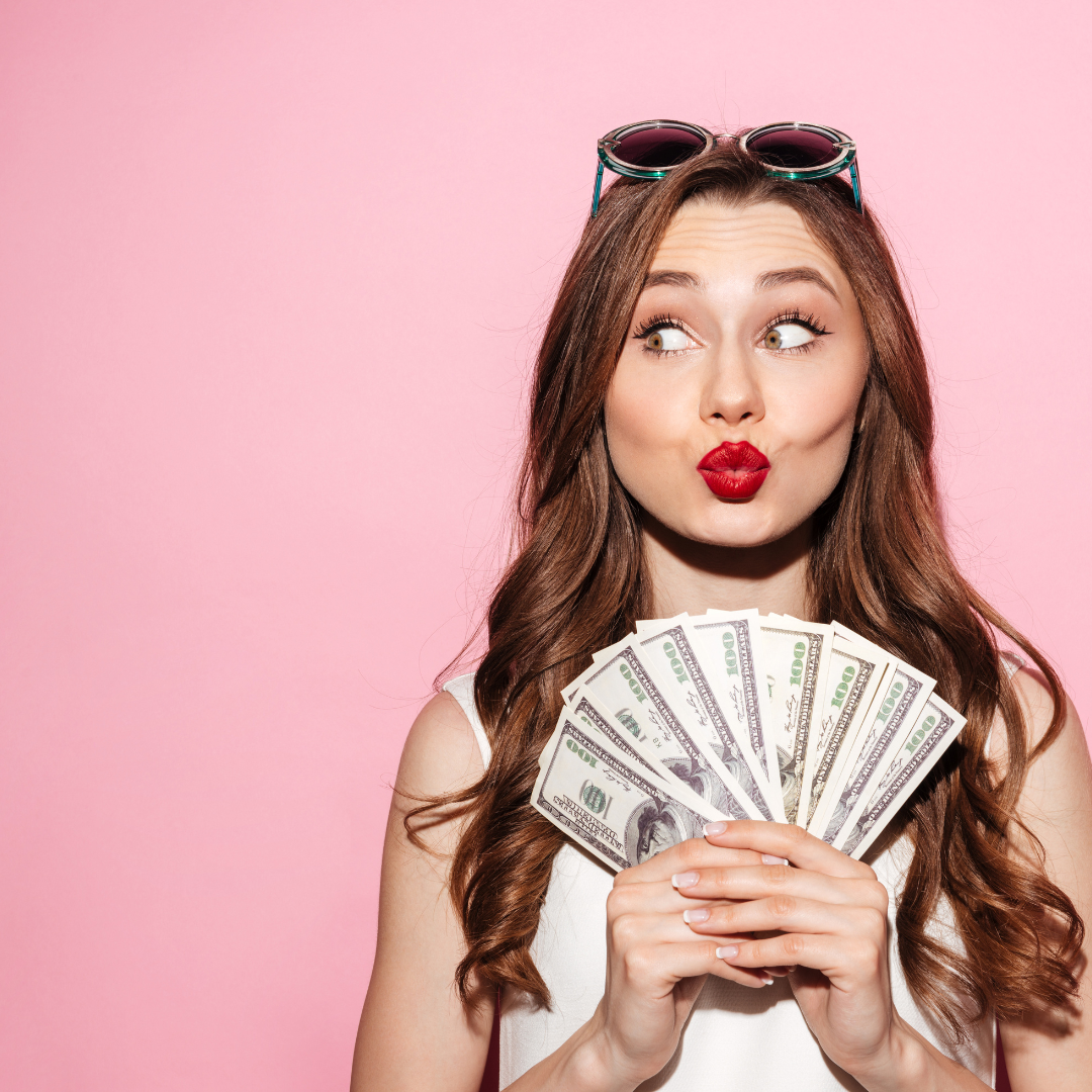 A lady holding a handful of cash to denote a growing business